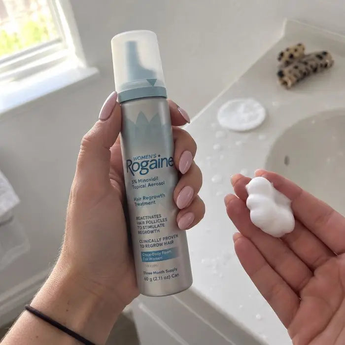 Minoxidil foam dispensed into a hand