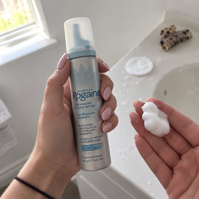Holding a can of minoxidil foam