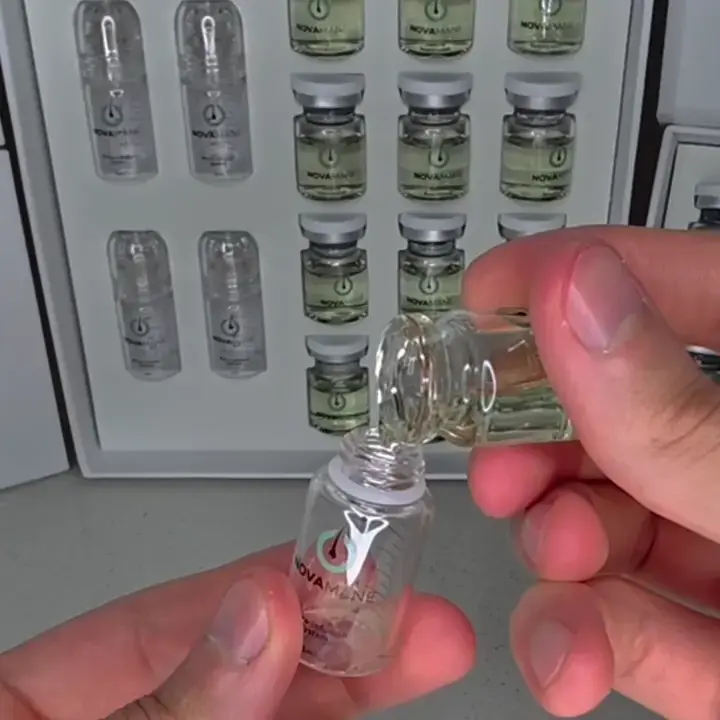 Hand holding a small vial labeled 'Novamed' with a background of similar vials.

